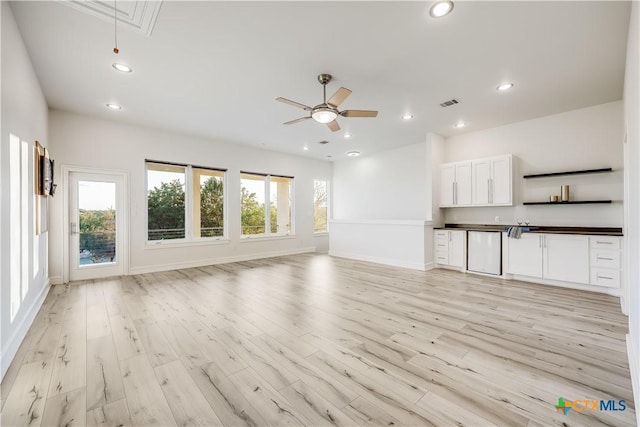 unfurnished living room featuring light hardwood / wood-style flooring and ceiling fan