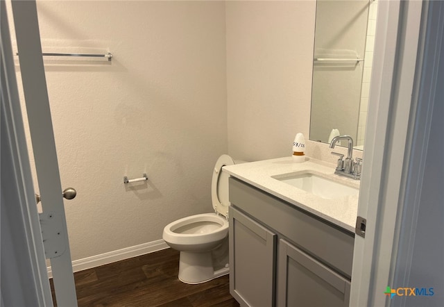 19712 Abigail Fillmore Rd, Manor, TX 78653 - bathroom featuring wood finished floors, vanity, toilet, and baseboards