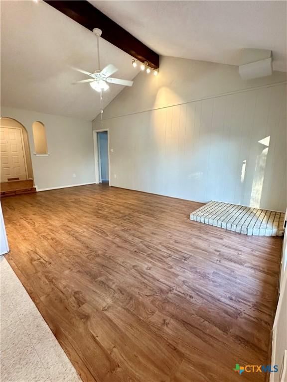 5407 Shirley St, Baytown, TX 77521 - unfurnished room featuring a ceiling fan, beamed ceiling, wood finished floors, arched walkways, and high vaulted ceiling