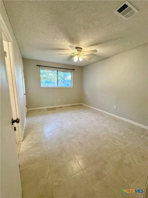 5407 Shirley St, Baytown, TX 77521 - unfurnished room featuring a ceiling fan, a textured ceiling, and baseboards
