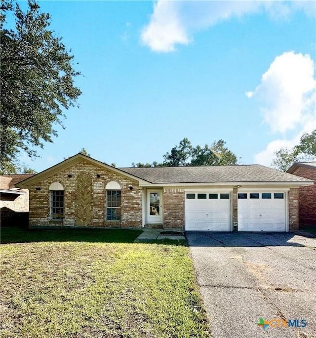 5407 Shirley St, Baytown, TX 77521 - ranch-style house with asphalt driveway, an attached garage, a front lawn, and brick siding
