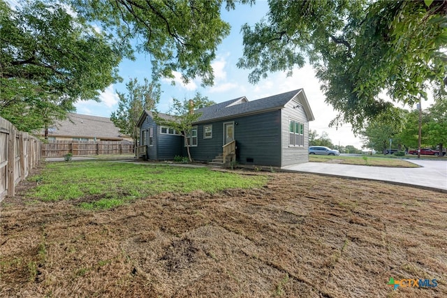 rear view of property featuring a yard