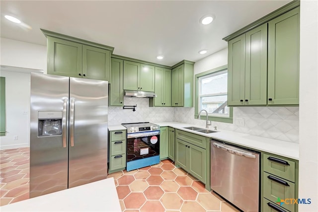 kitchen featuring decorative backsplash, appliances with stainless steel finishes, sink, and green cabinetry