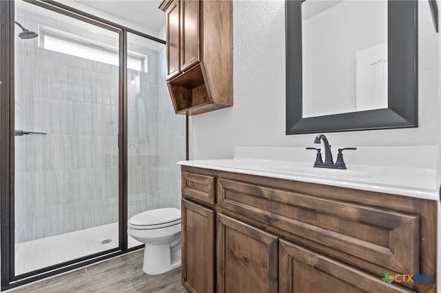 bathroom with vanity, toilet, and walk in shower