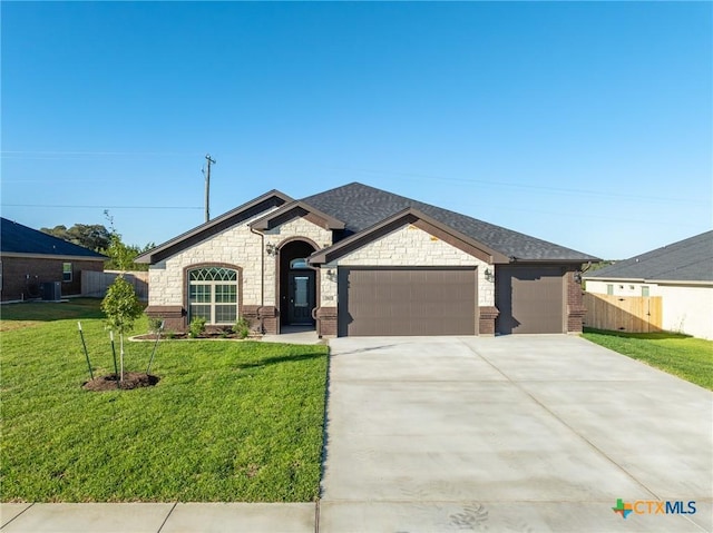 view of front facade with a garage and a front lawn