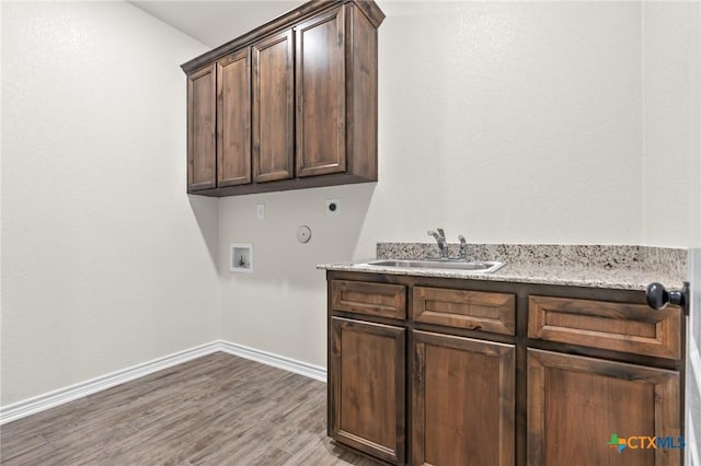 laundry room featuring sink, cabinets, washer hookup, electric dryer hookup, and wood-type flooring