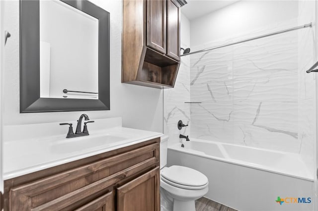 full bathroom featuring hardwood / wood-style floors, vanity, toilet, and shower / tub combination