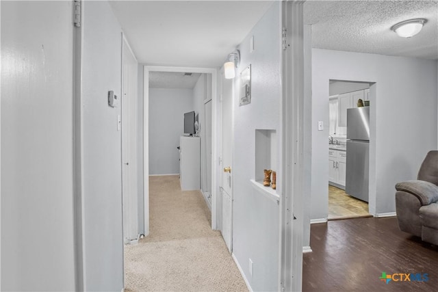 138 Antrim Dr, San Antonio, TX 78218 - corridor with a textured ceiling, baseboards, and light wood finished floors