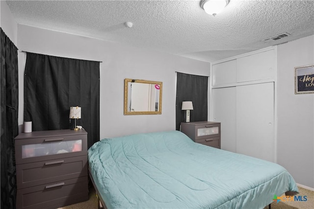 138 Antrim Dr, San Antonio, TX 78218 - bedroom with a textured ceiling, carpet, and a closet