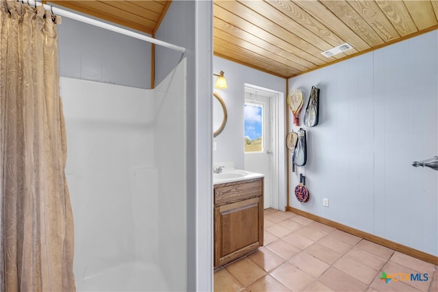 bathroom with vanity, wood walls, tile patterned floors, and wood ceiling