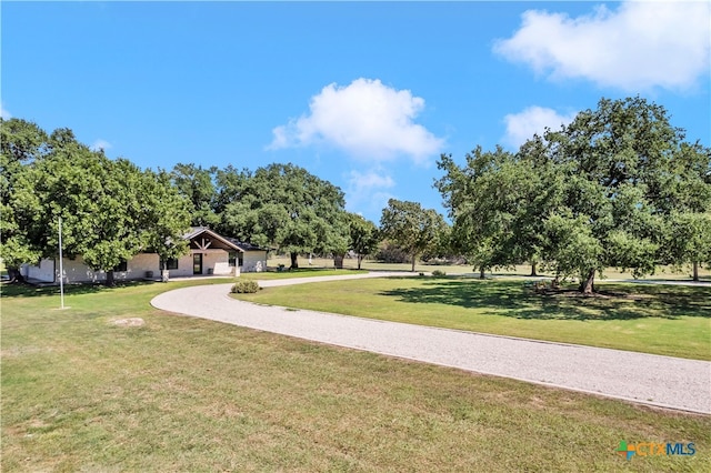 view of property's community with a lawn