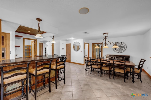 dining room with bar and light tile patterned floors