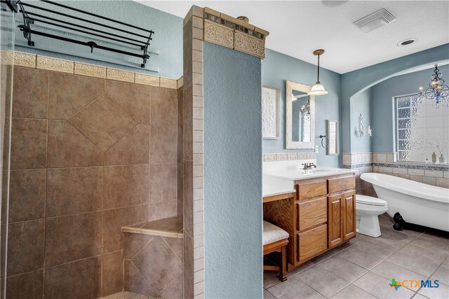 full bathroom featuring toilet, tile patterned floors, tile walls, plus walk in shower, and vanity