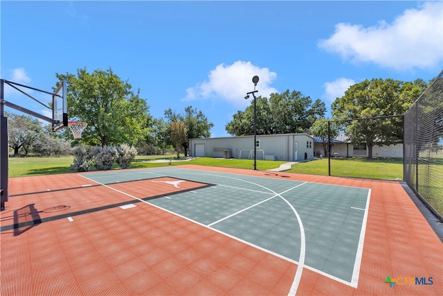 view of basketball court with a yard