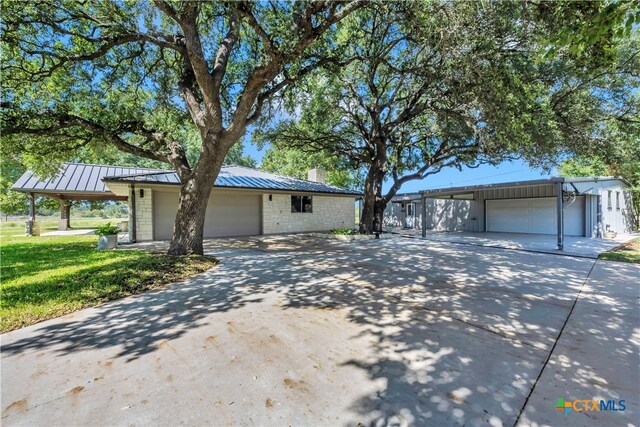 ranch-style home featuring a garage and a front yard