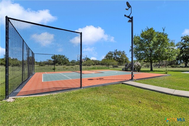 view of basketball court featuring a yard