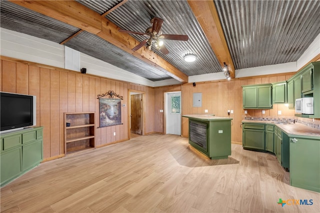 kitchen featuring green cabinetry, ceiling fan, a kitchen island, beam ceiling, and light hardwood / wood-style flooring