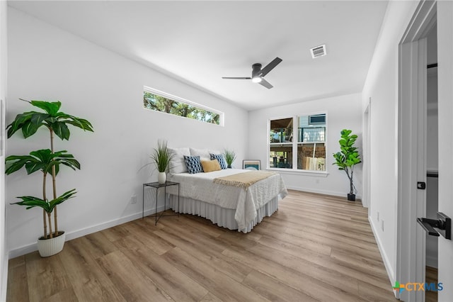 bedroom featuring visible vents, baseboards, and light wood-style floors