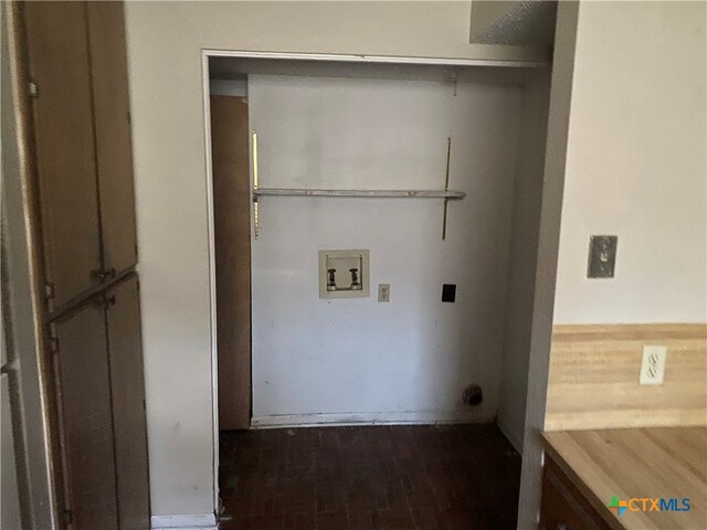 clothes washing area featuring hookup for an electric dryer, dark hardwood / wood-style flooring, and washer hookup