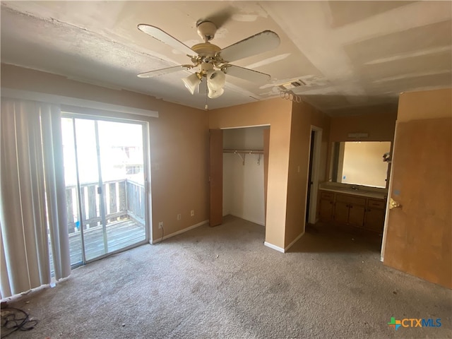 unfurnished bedroom with a closet, access to outside, light colored carpet, and ceiling fan