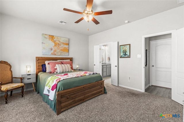 carpeted bedroom with connected bathroom, baseboards, visible vents, and a ceiling fan