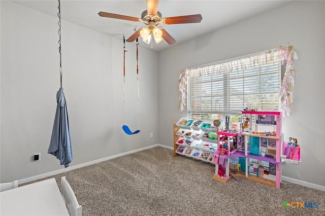 game room with baseboards, carpet, and ceiling fan