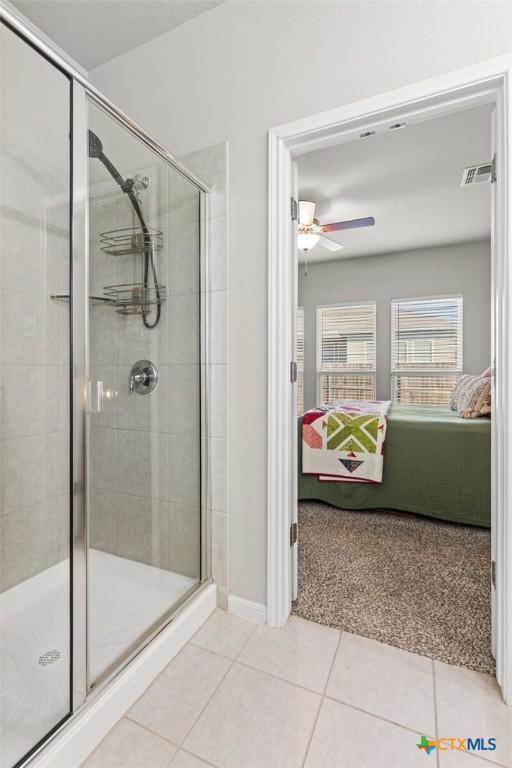 ensuite bathroom with visible vents, a shower stall, and ensuite bathroom