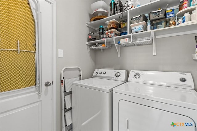 washroom featuring laundry area and washing machine and clothes dryer