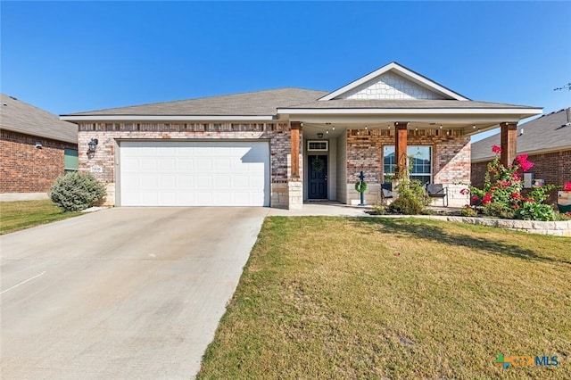 view of front of home with brick siding, driveway, a front lawn, and an attached garage