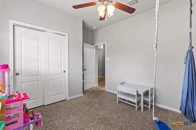 playroom featuring carpet, a ceiling fan, visible vents, and baseboards