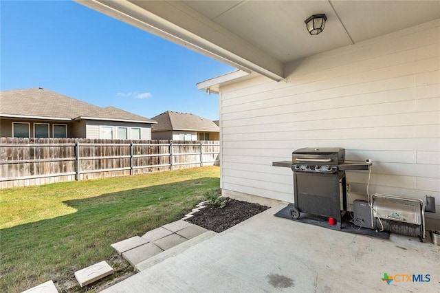 view of patio with a grill and fence