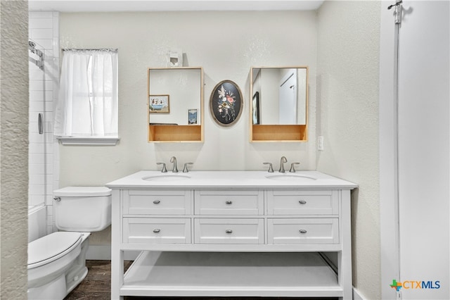 bathroom featuring vanity, wood-type flooring, and toilet