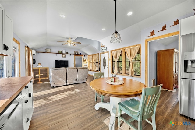 dining space with wood-type flooring, ceiling fan, and lofted ceiling