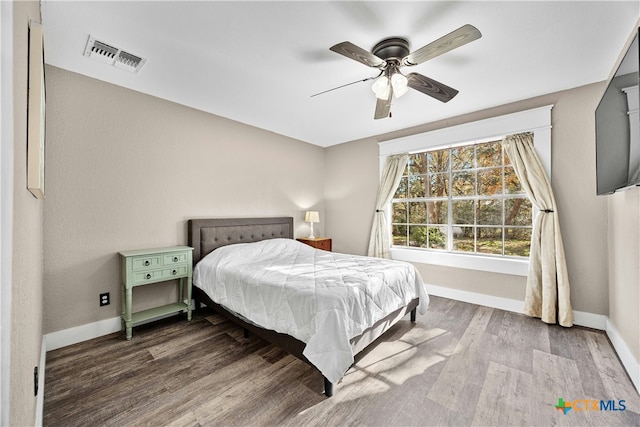 bedroom with ceiling fan and wood-type flooring