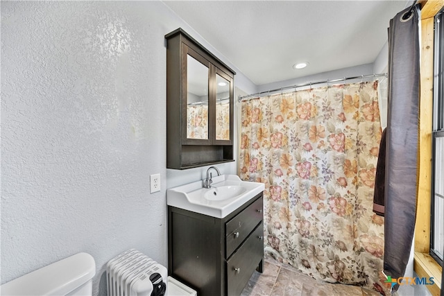 bathroom with vanity, a shower with shower curtain, and toilet