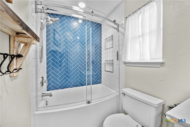 bathroom with toilet and enclosed tub / shower combo