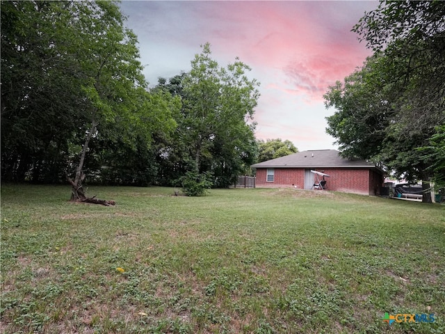 view of yard at dusk