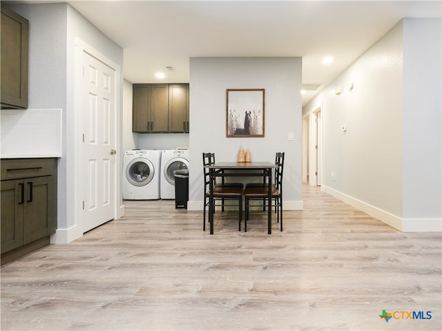 dining room with light hardwood / wood-style floors and washing machine and clothes dryer