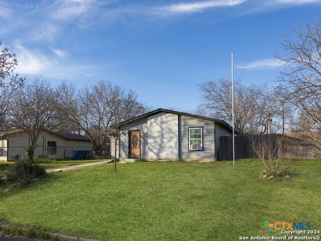 ranch-style home with a front lawn