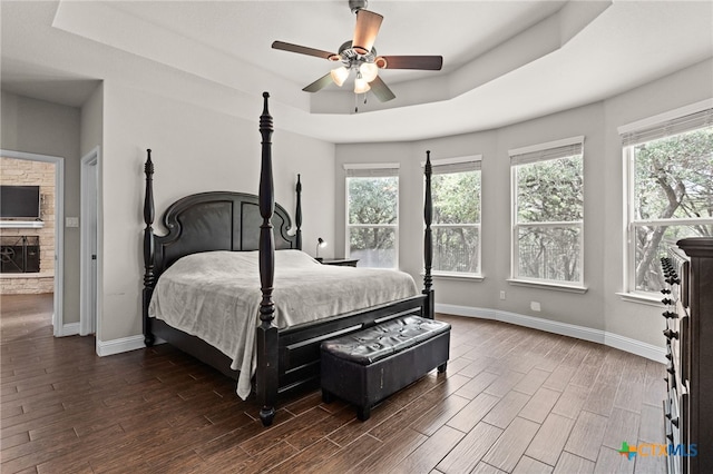 3256 Province Pt, Harker Heights, TX 76548 - bedroom featuring multiple windows, dark wood finished floors, a tray ceiling, and ceiling fan