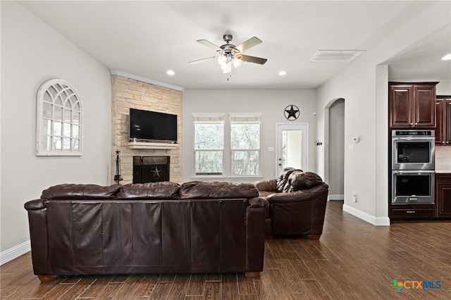 3256 Province Pt, Harker Heights, TX 76548 - living room with a ceiling fan, dark wood-style floors, arched walkways, a stone fireplace, and recessed lighting