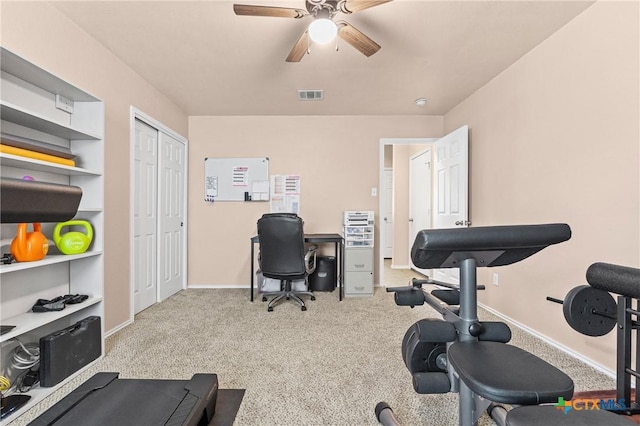 exercise room with baseboards, a ceiling fan, visible vents, and carpet flooring