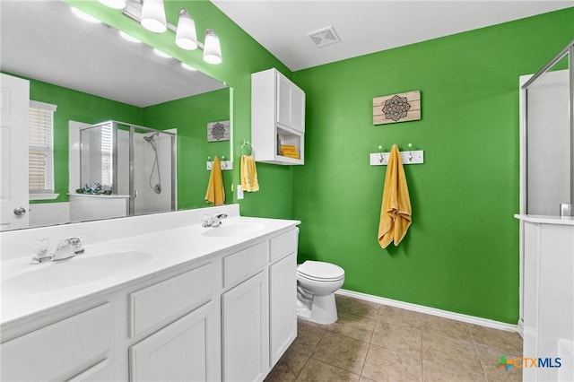 full bath featuring double vanity, visible vents, a stall shower, and a sink