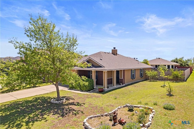 exterior space with a lawn, a chimney, fence, and driveway