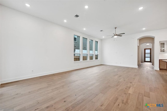 264 Five Mile Creek Way, Kyle, TX 78640 - empty room featuring arched walkways, ceiling fan, light wood-style flooring, recessed lighting, and baseboards