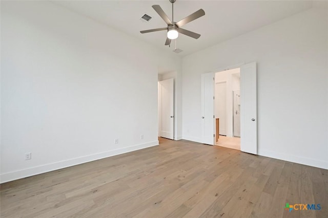 264 Five Mile Creek Way, Kyle, TX 78640 - unfurnished bedroom with wood finished floors and a ceiling fan