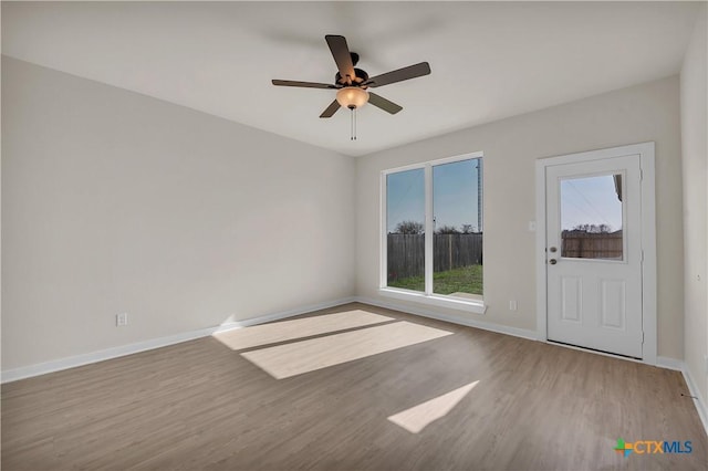 empty room featuring hardwood / wood-style flooring and ceiling fan