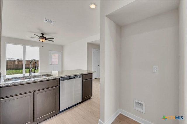 kitchen with sink, ceiling fan, light hardwood / wood-style floors, light stone countertops, and stainless steel dishwasher