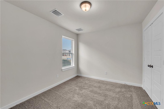 unfurnished bedroom featuring carpet and a closet