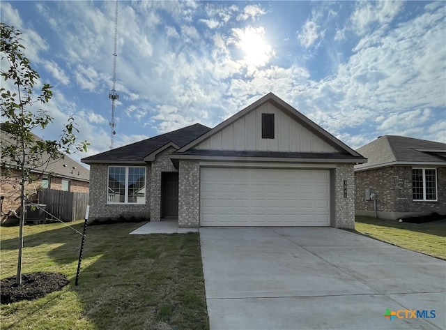 view of front of home with a front yard and a garage